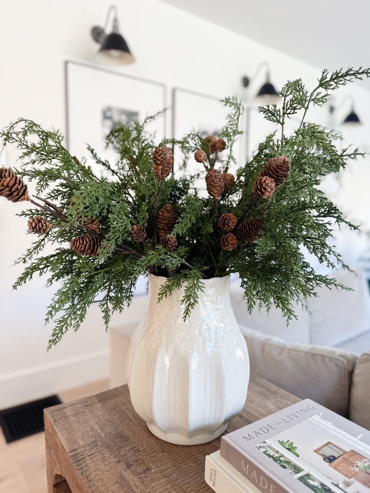 evergreen-sprigs-in-a-white-stoneware-vase-for-winter-decor
