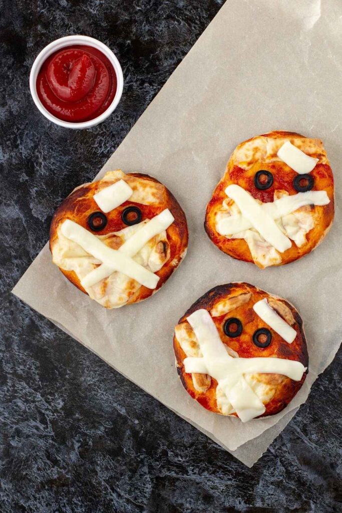 mini-pizza-as-mummy-for-kids-with-cheese-olives-and-ketchup