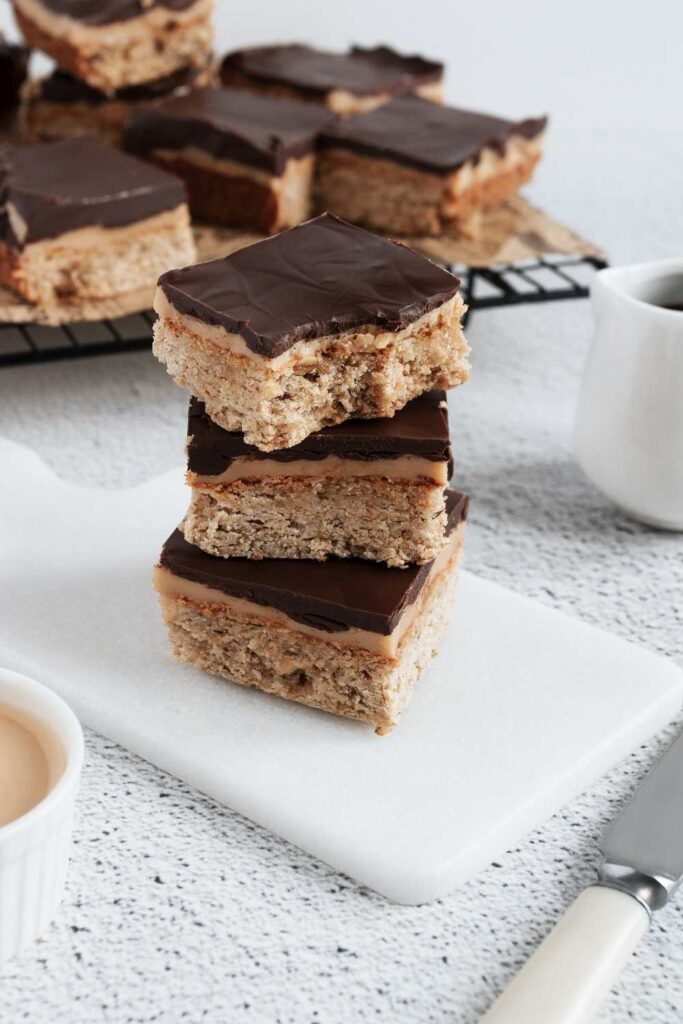 Stack-of-no-bake-peanut-butter-bars-topped-with-a-layer-of-dark-chocolate