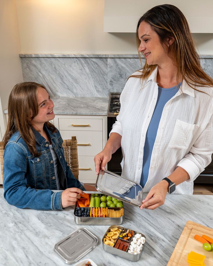mom-preparing-school-lunch-with-child-morning-routine-in-kitchen