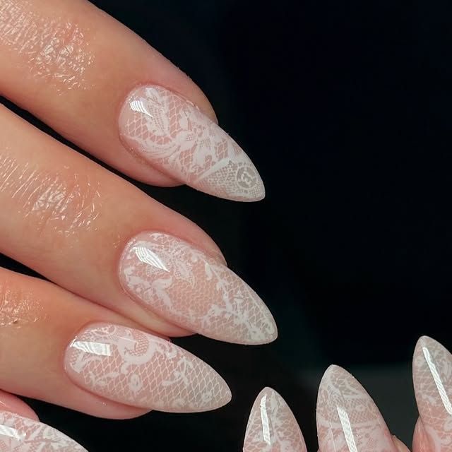 delicate-white-lace-nail-art-on-glossy-stiletto-almond-nails
