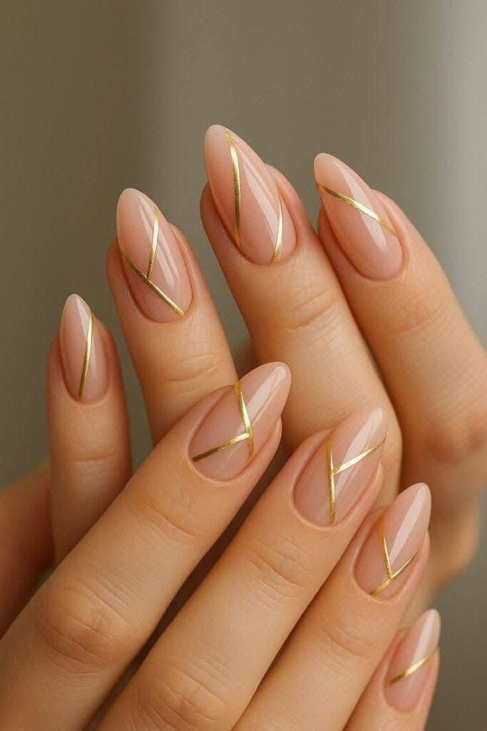 geometric-gold-line-art-on-nude-glossy-almond-nails