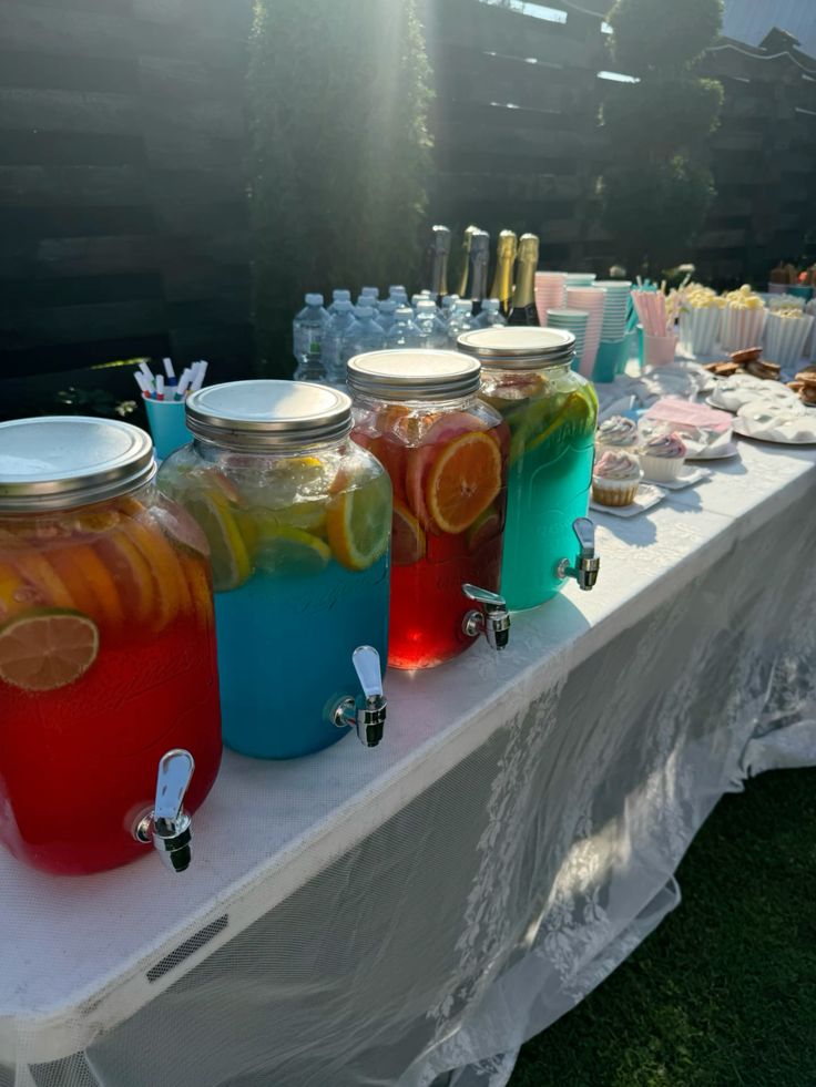 glass-drink-dispensers-with-colorful-fruit-punches-for-a-baby-shower