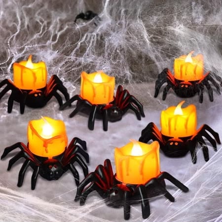 flame-less-battery-operated-tea-light-candles-shaped-like-black-spiders-with-glowing-orange-melted-wax-tops