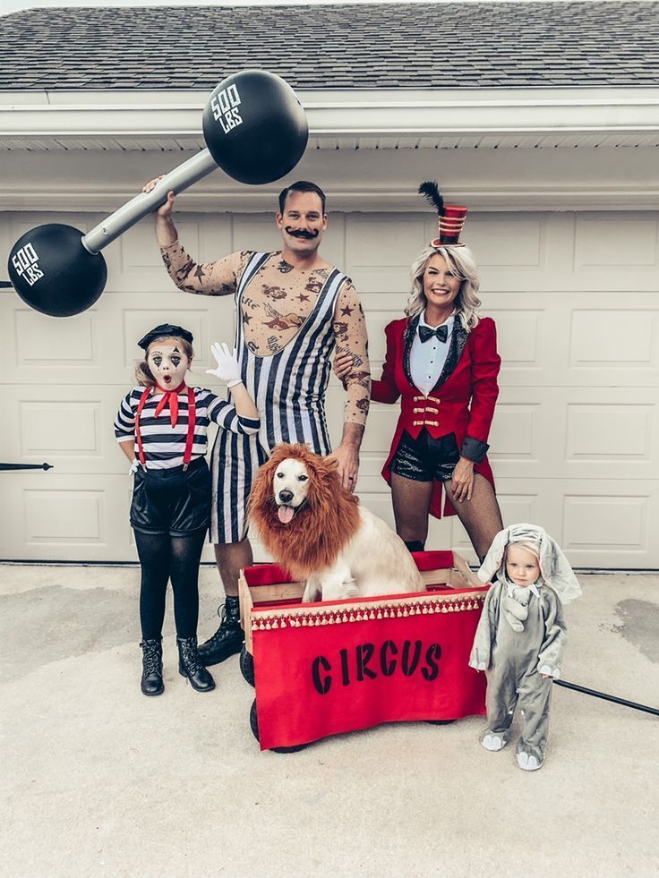 family-dressed-in-circus-costumes-as-a-strongman-ringmaster-mime-baby-elephant-and-dog-as-a-lion