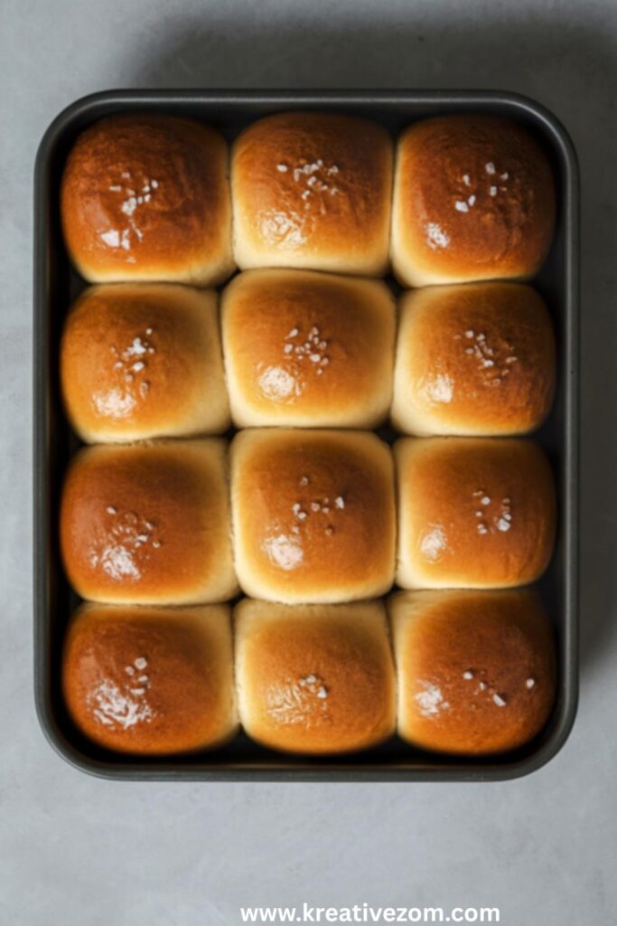 golden-brown-baked-dinner-rolls-sprinkled-with-sea-salt-in-a-baking-pan