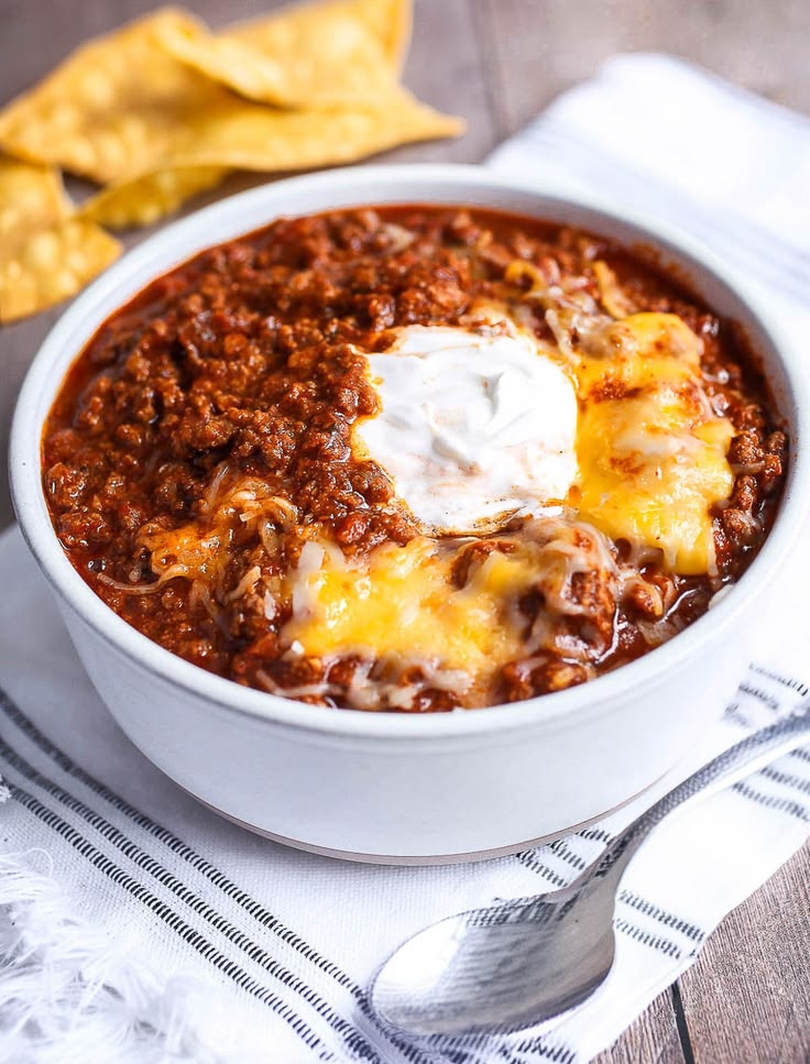 bowl-of-beef-chili-topped-with-melted-cheese-and-sour-cream-easy-christmas-party-potluck-ideas
