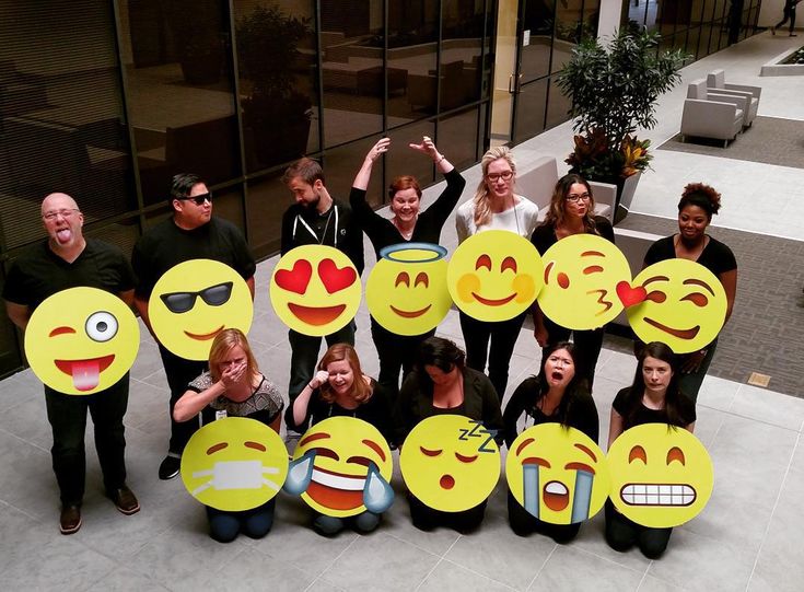 large-group-holding-yellow-emoji-face-cutouts-matching-their-facial-expressions