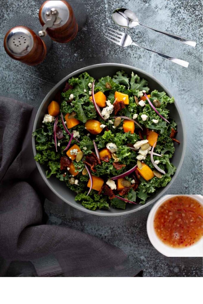 harvest-kale-salad-with-roasted-squash-red-onion-pumpkin-seeds-and-crumbled-cheese-easy-thanksgiving-potluck-ideas