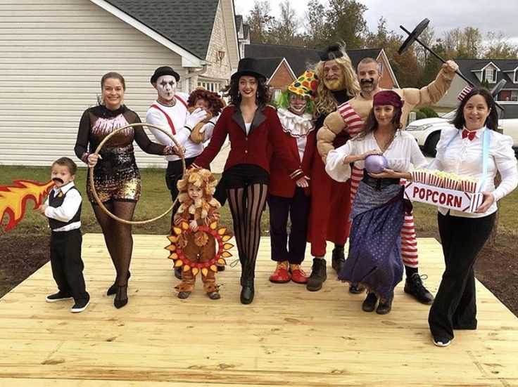 family-and-friends-dressed-in-circus-costumes-including-a-ringmaster-clown-fortune-teller-lion-and-popcorn-vendor