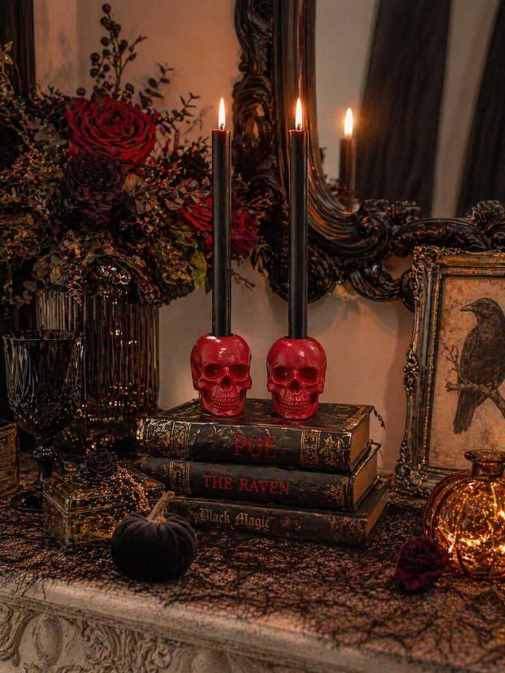 gothic-halloween-table-setup-featuring-red-skull-candle-holders-with-black-taper-candles
