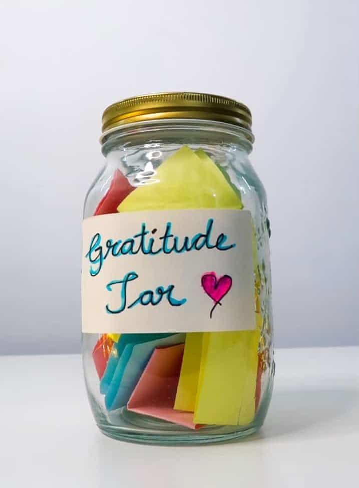 glass-gratitude-jar-filled-with-colorful-notes-and-a-labeled-front-tag