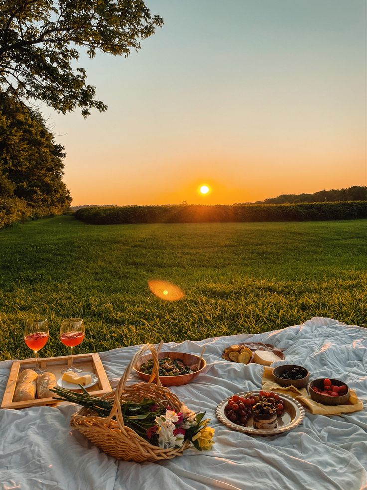 cozy-outdoor-sunset-picnic-setup-with-wine-bread-and-fruit
