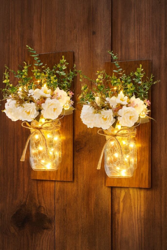 hanging-wooden-mason-jar-wall-sconces-with-fairy-lights-and-white-flowers
