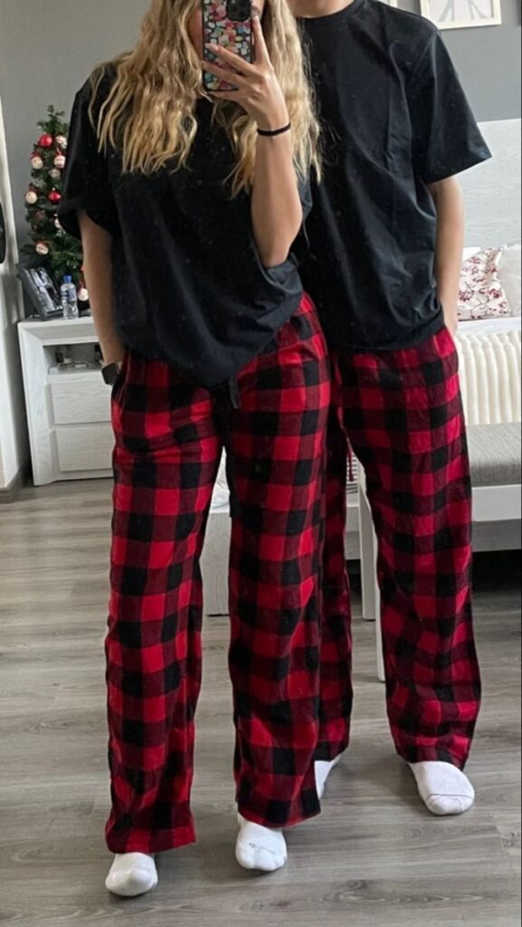 Two-people-from-the-waist-down-in-a-mirror-selfie-wearing-identical-black-t-shirts-and-red-plaid-pajama-pants-for-Valentines-Day-gift-ideas