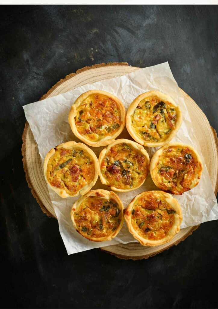 baked-mini-spinach-and-bacon-quiches-on-a-wooden-board