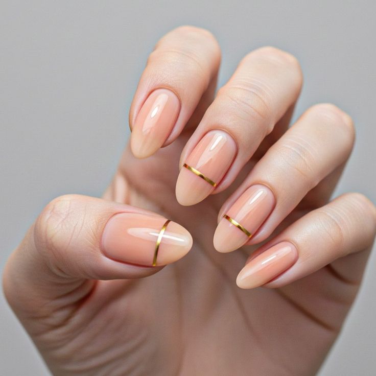 minimalist-nude-almond-nails-with-subtle-horizontal-gold-metallic-stripe