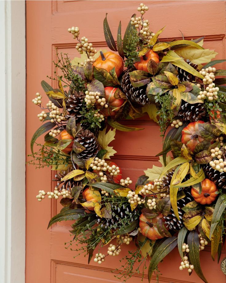 autumn-door-wreath-made-with-pinecones-mini-pumpkins-and-foliage