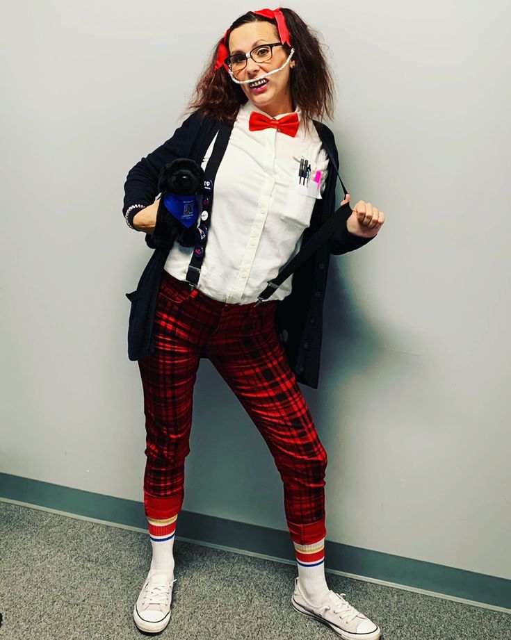a-woman-wearing-glasses-suspenders,-and stripe-trousers