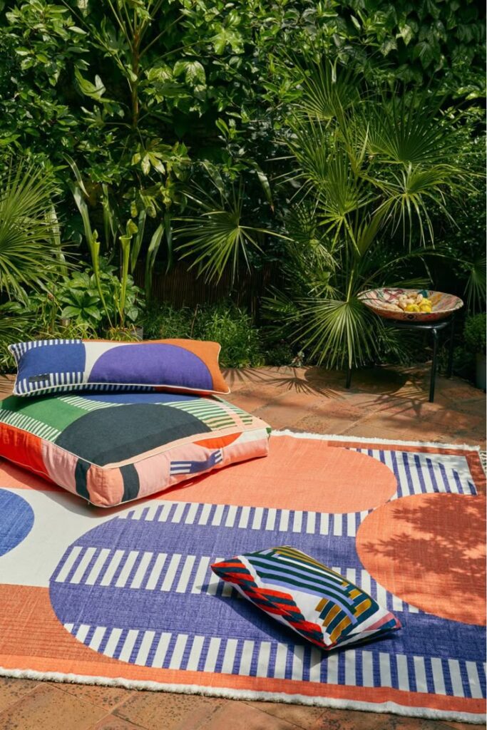 colorful-organic-fabric-floor-cushions-and-outdoor-rug-on-patio