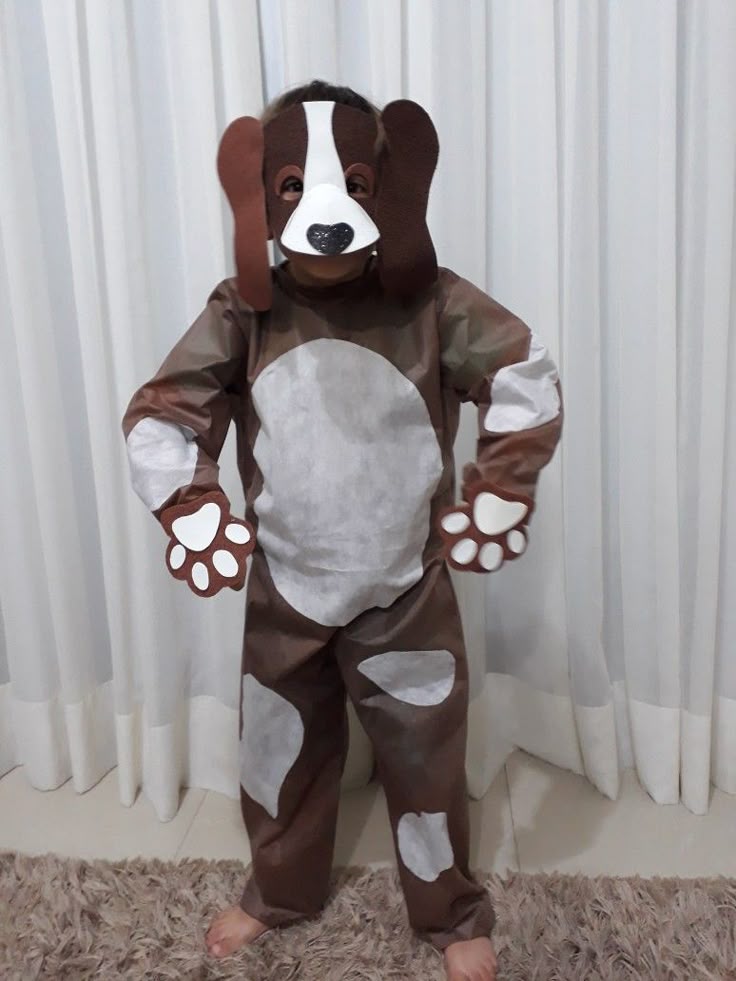 child-dressed-in-a-brown-and-white-spotted-dog-costume-with-a-matching-puppy-headpiece-and-paws
