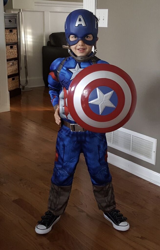 young-boy-dressed-in-a-captain-america-superhero-costume-holding-a-matching-star-shield