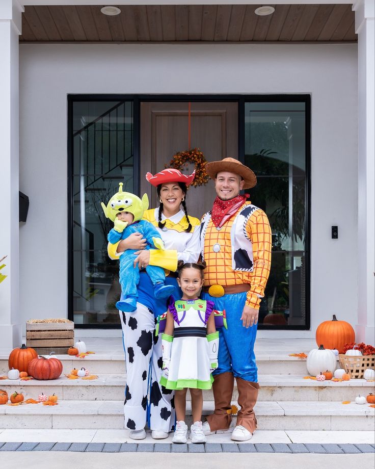family-wearing-toy-story-costumes-as-jessie-woody-buzz-lightyear-and-alien