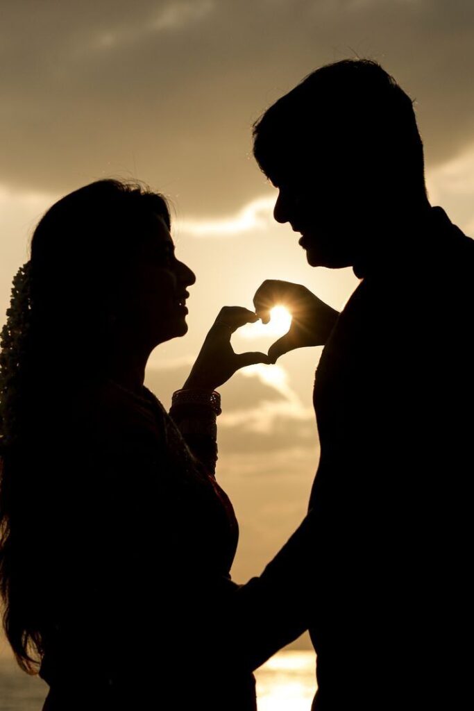 sunset-silhouette-of-couple-making-a-heart-shape-with-their-hands