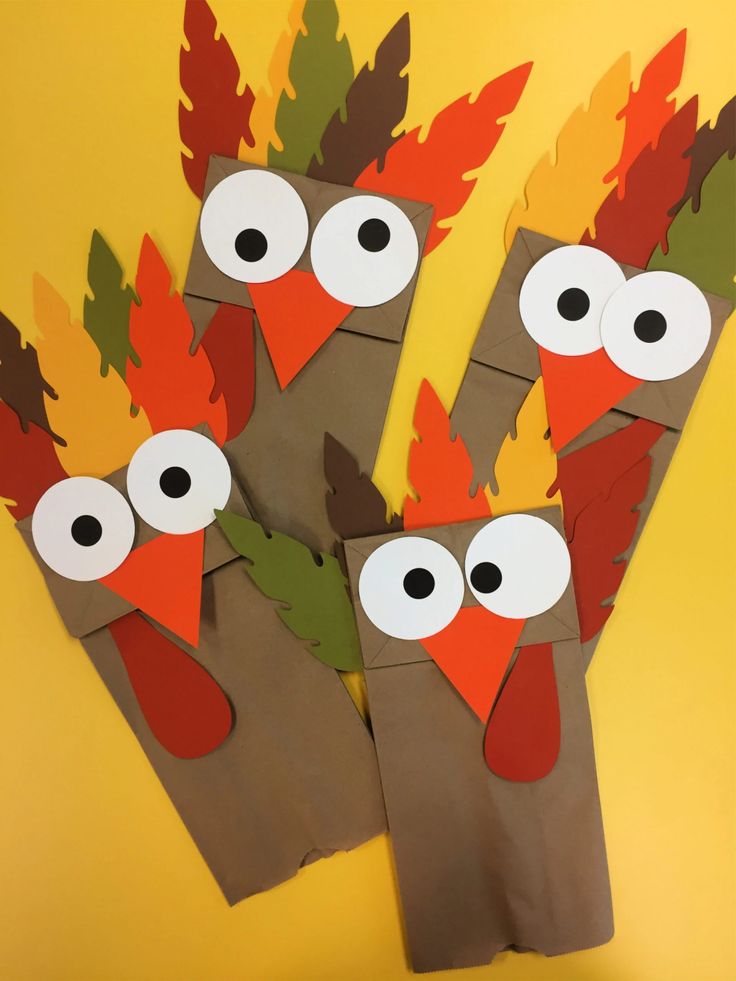 four-turkey-paper-bag-puppets-with-colorful-paper-feathers-and-googly-eyes-for-thanksgiving-crafts-ideas-for-thanksgiving-crafts-ideas