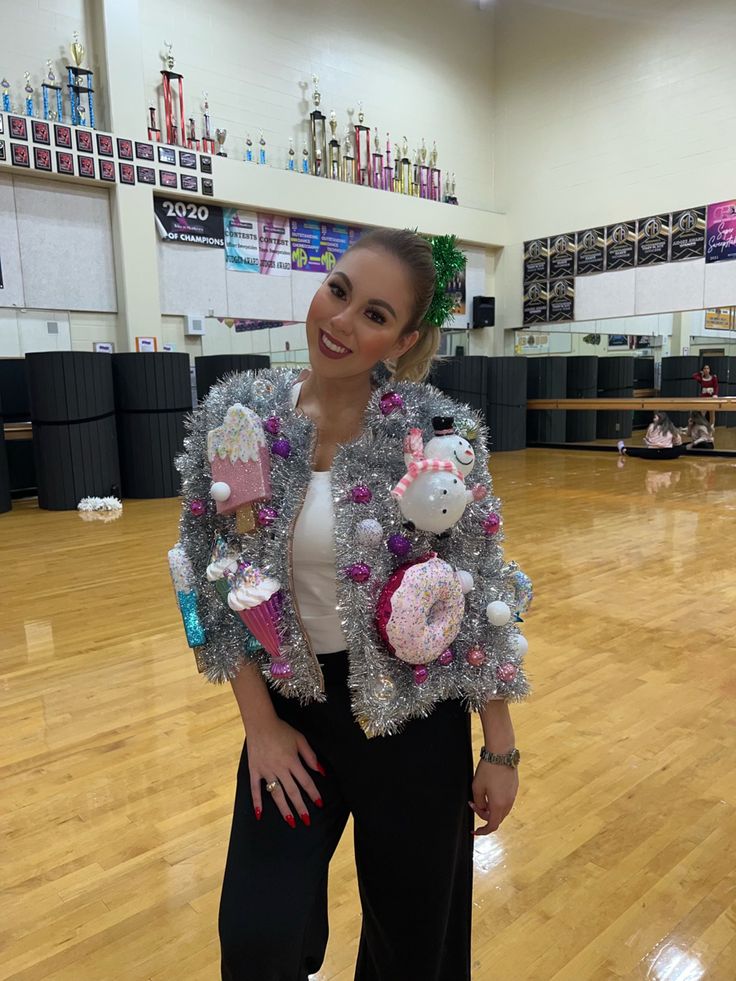 woman-in-tinsel-jacket-decorated-with-holiday-ornaments-in-gymnasium