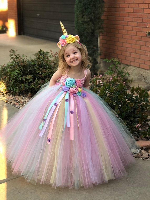 young-girl-wearing-a-colorful-rainbow-tulle-unicorn-dress-with-a-gold-horn-and-floral-headband-for-halloween-costume-ideas-for-kids