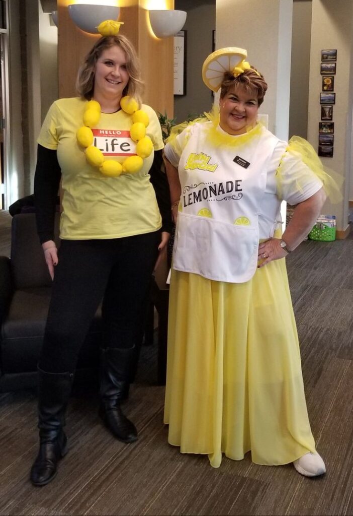 two-women-wearing-lemon-on-their-neck-and-vest-written-lemonade-for-When-life-gives-you-lemons-make-lemonade. -costume-ideas