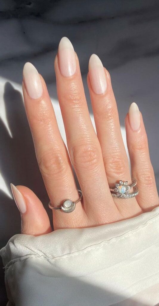 iridescent-pearl-white-shimmer-almond-nails-with-subtle-glow