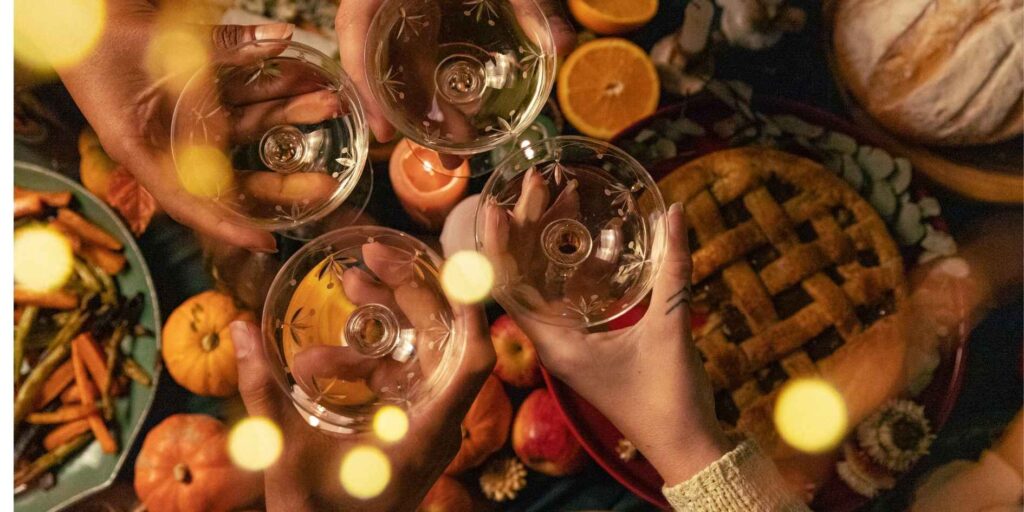 hands-holding-glass-wine-and-toasting-together