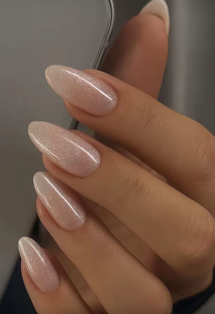 minimalist-silver-micro-glitter-overlay-almond-nails-with-glossy-nude-base-for-wedding-nails-for-brides 
