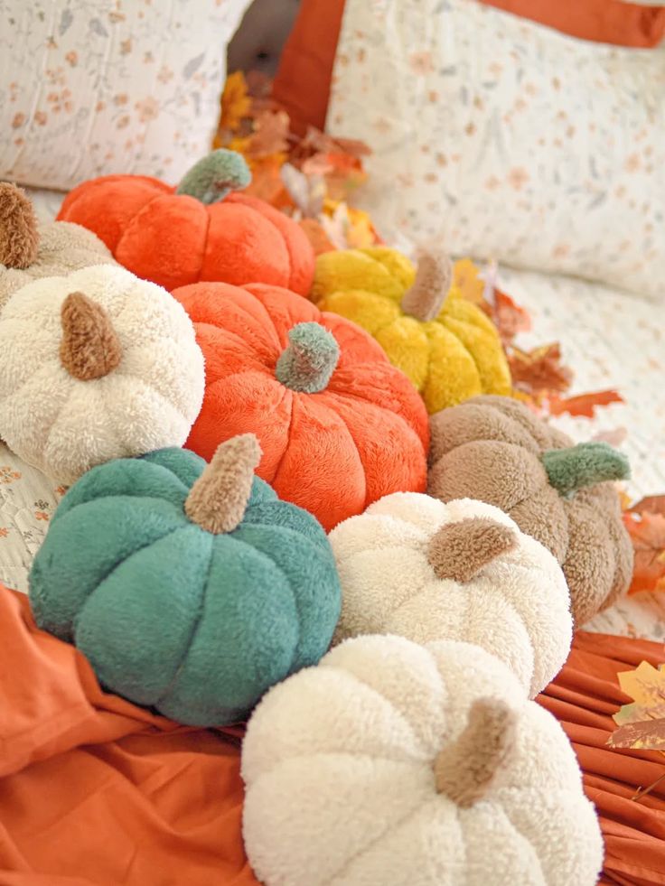 collection-of-soft-fleece-and-boucle-plush-pumpkins-in-orange-teal-mustard-white-and-brown