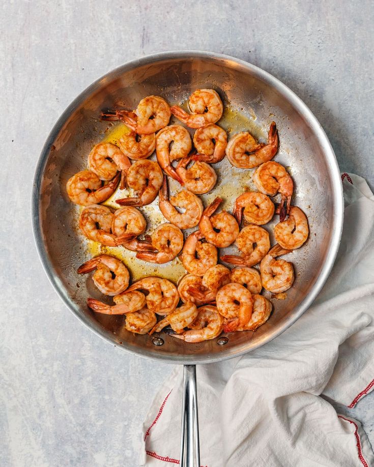sauteing-seasoned-raw-shrimp-in-olive-oil-stainless-steel-skillet-step-1