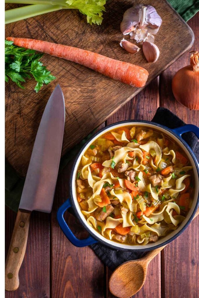 pot-of-chicken-noodle-soup-surrounded-by-carrots-celery-and-garlic-easy-dinner-recipes