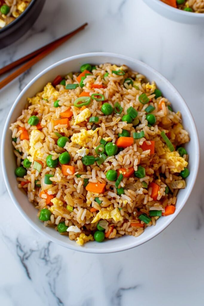 bowl-of-classic-vegetable-fried-rice-with-green-peas-carrots-and-scrambled-eggs