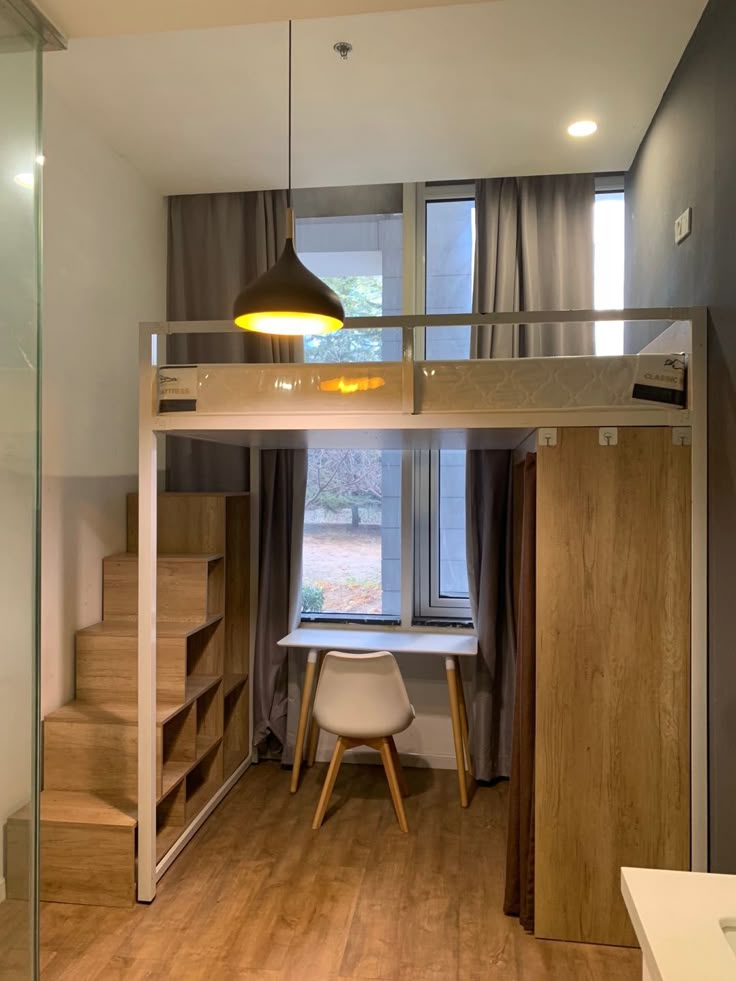 space-saving-loft-bed-featuring-built-in-cube-storage-stairs-and-a-study-desk-tucked-underneath-in-a-compact-room