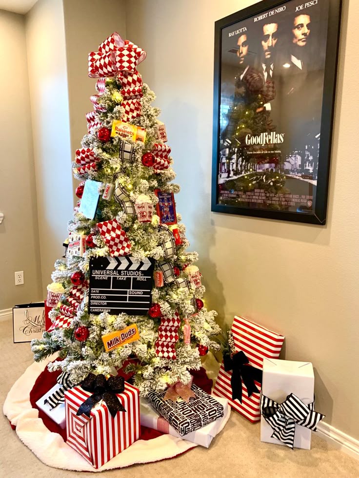 movie-night-themed-christmas-tree-adorned-with-a-film-director-clapboard-popcorn-boxes-candy-boxes-and-checkerboard-ribbon