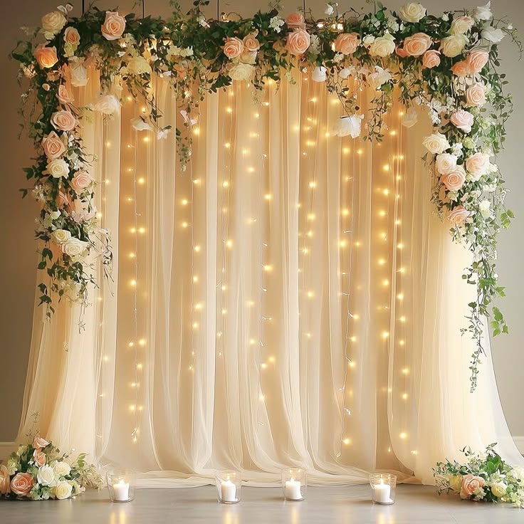 sheer-champagne-curtain-wedding-backdrop-with-fairy-lights-and-floral-garland