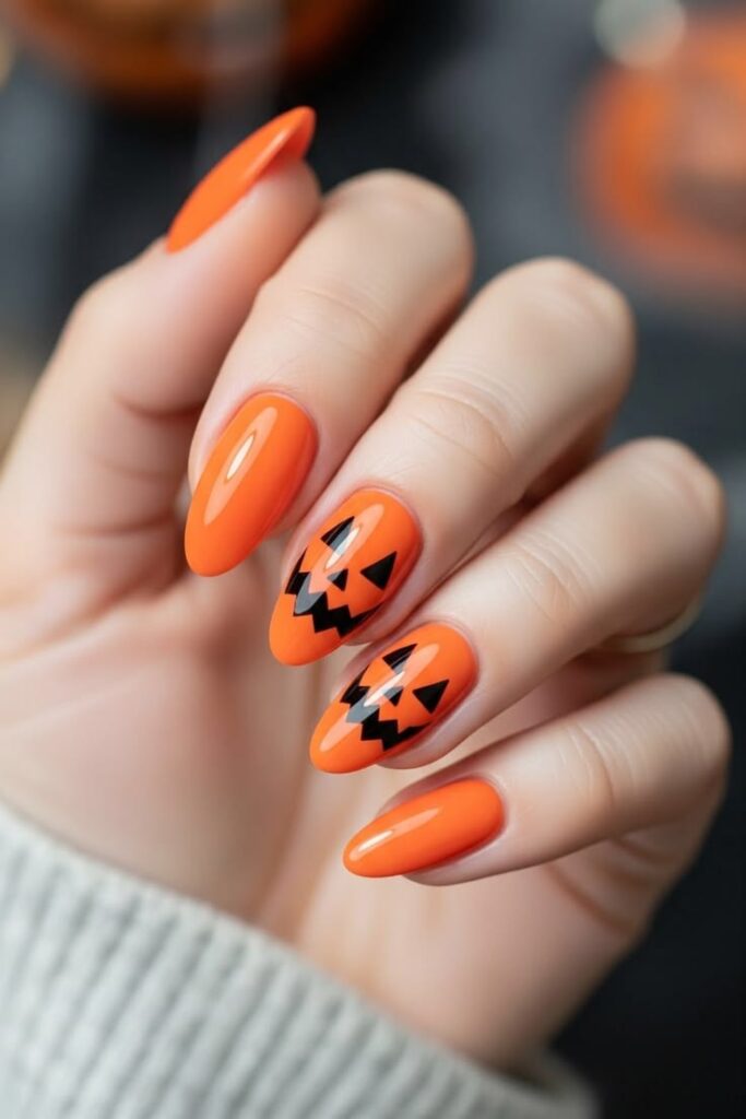 simple-jack-o-lantern-face-nail-art-on-orange-almond-nails