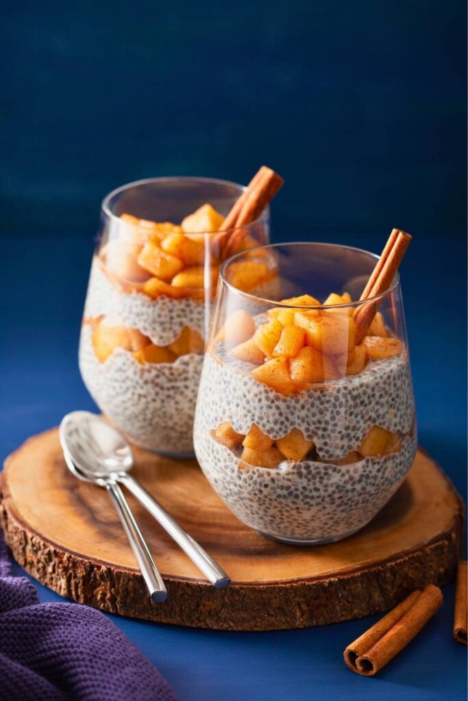 spiced-chia-seed-pudding-layered-with-cinnamon-diced-apples-in-glass-cups-garnished-with-cinnamon-sticks-for-fall-breakfast-ideas