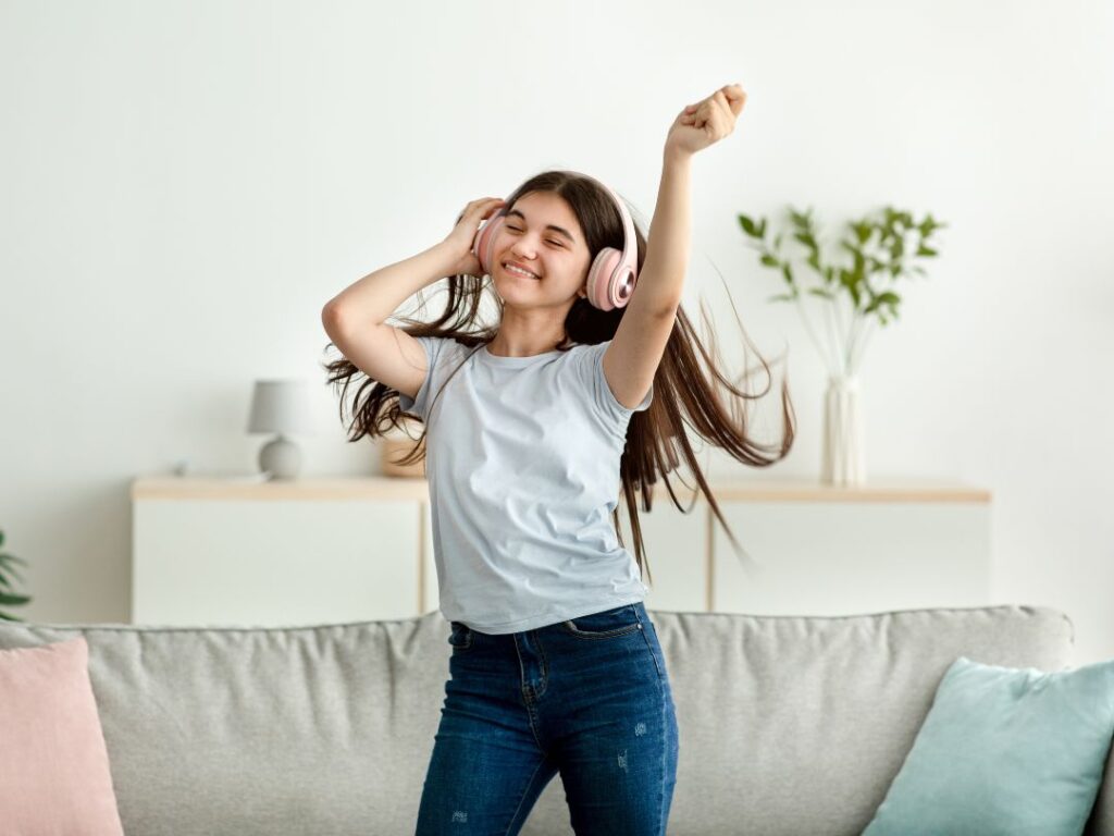 young-girl-wearing-headphones-dancing-happily-alone-in-a-living-room