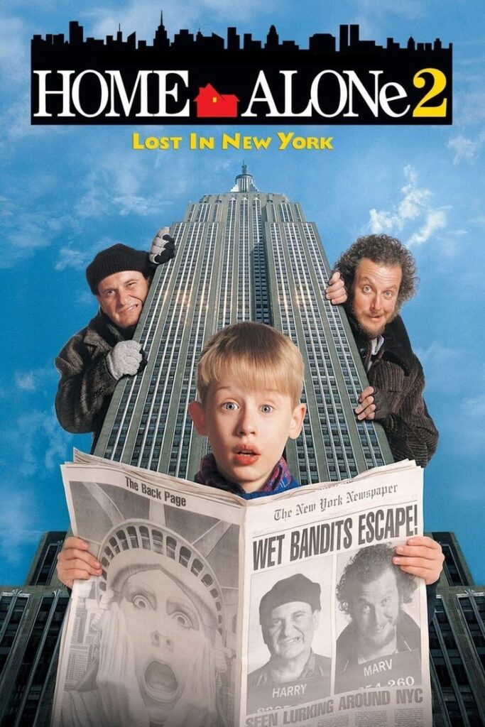 movie-poster-for-home-alone-2-lost-in-new-york-starring-macaulay-culkin-holding-a-newspaper-in-front-of-a-skyscraper-with-the-wet-bandits-behind-him-hard-classic-Christmas-movies
