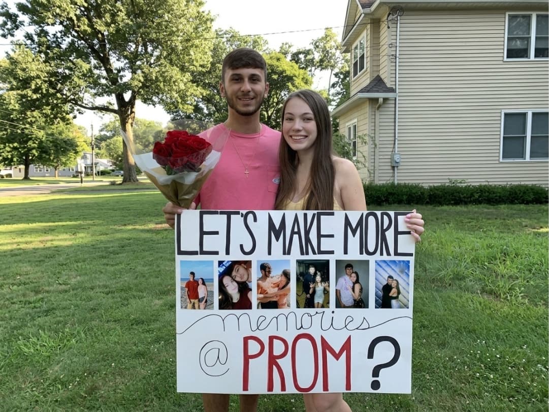 couple-holding-photo-collage-promposal-sign-and-red-roses-outdoors
