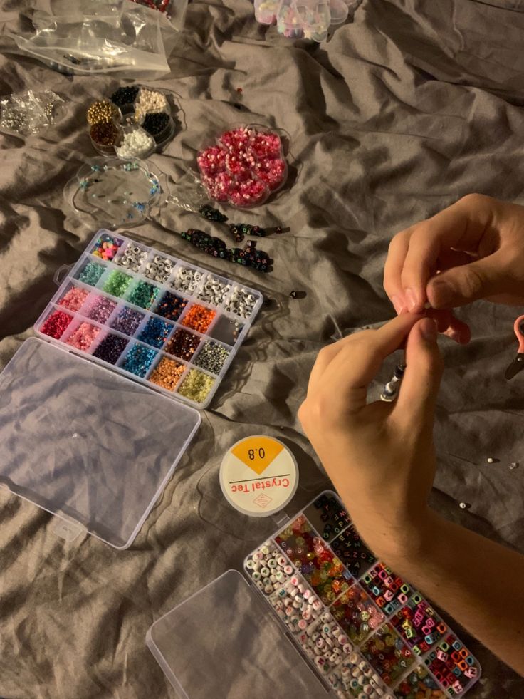 person-making-beaded-friendship-bracelets-with-colorful-bead-kits